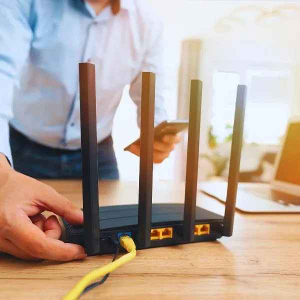 Man turning off his router to create a safe sleep environment at night