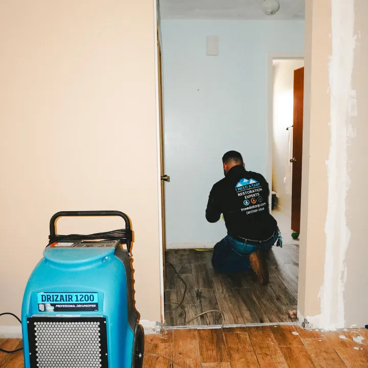 Dehumidifier positioned to circulate air across wet materials