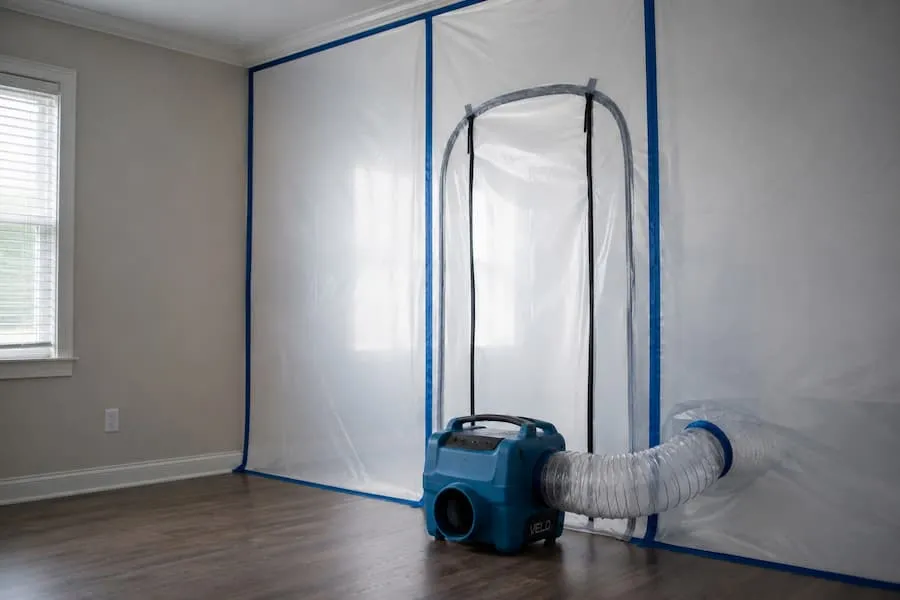 Containment sheeting and ducting set up in a room during mold remediation