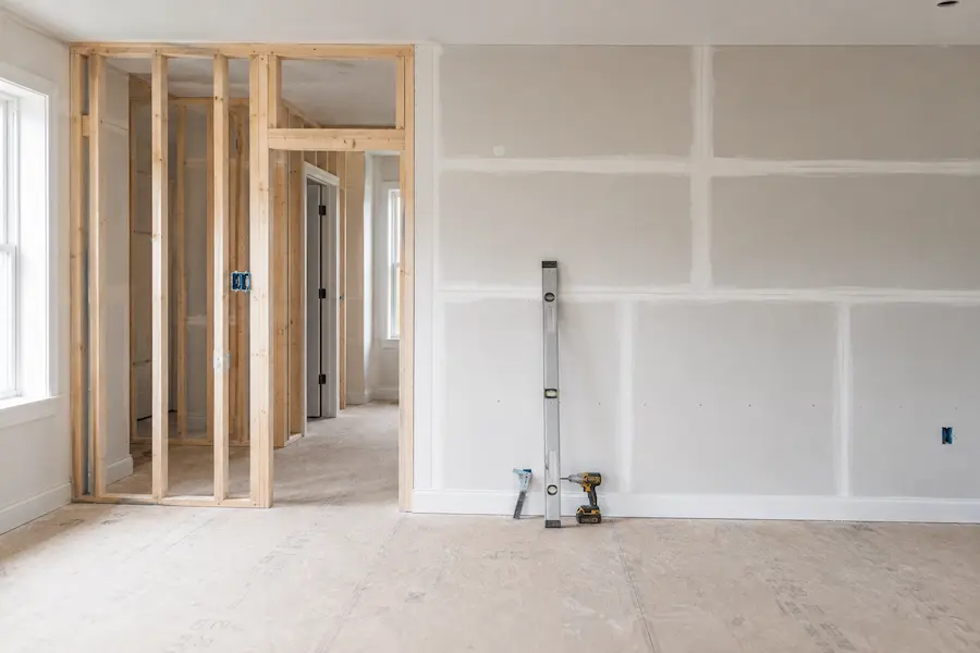 mpty room with new drywall and framing during reconstruction