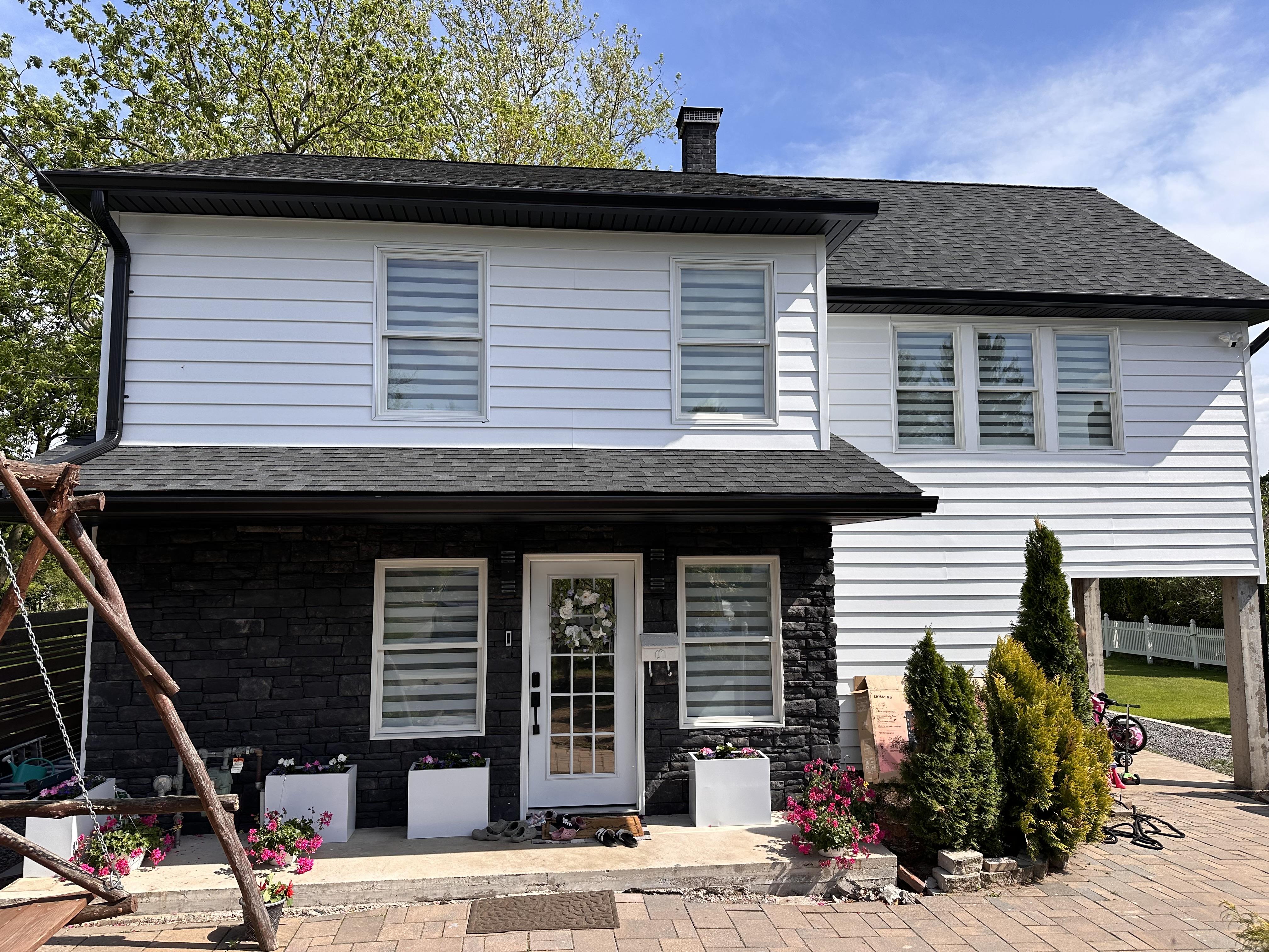 Sleek gutters and new roof on modern black and white pa home