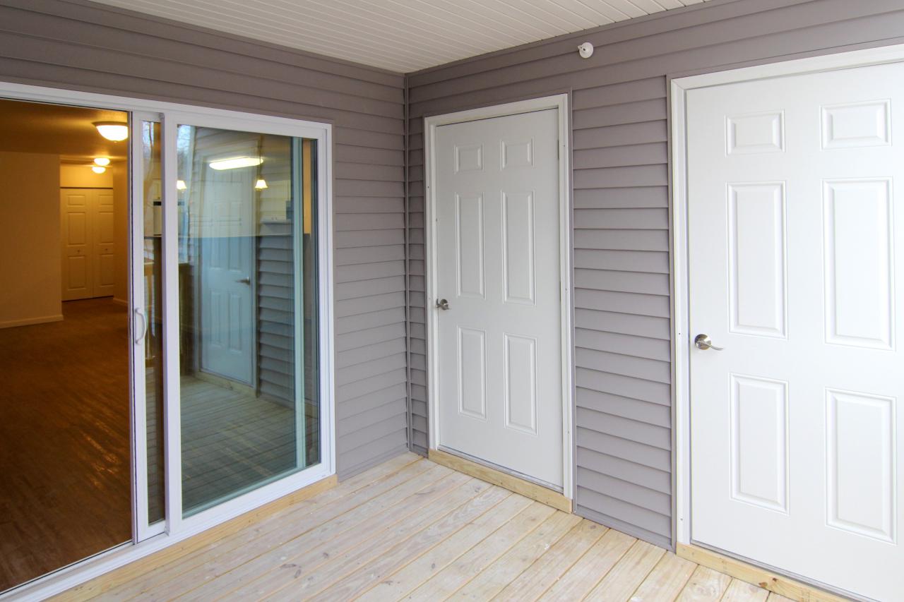 Modern white kitchen with wooden accent wall