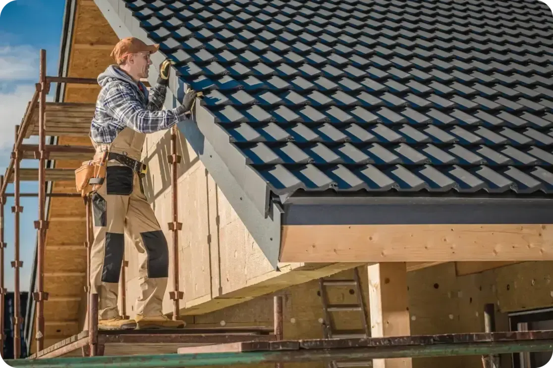 Roofer performing routine maintenance on a residential roof, inspecting shingles and structural components.