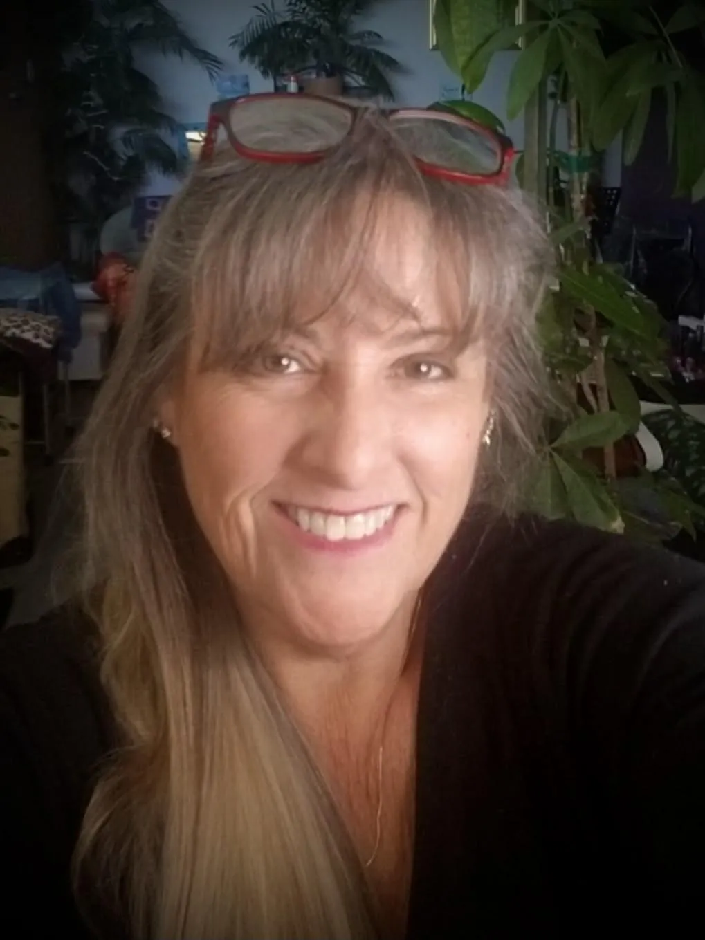 Nancy Badger, a professional singing teacher with long blonde hair, smiling into the camera against a black background.