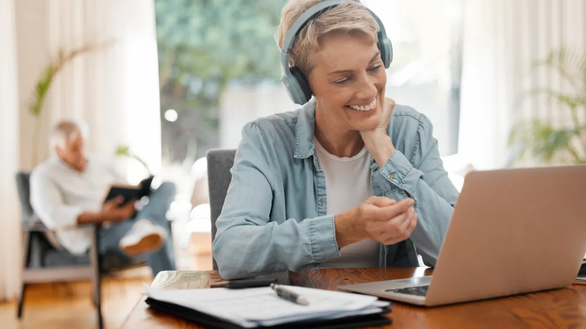 Colleagues collaborating at a modern office desk.