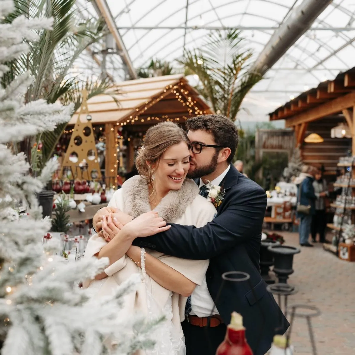 Christmas themed wedding portrait of bride and groom kissing at Watering Can Niagara Falls