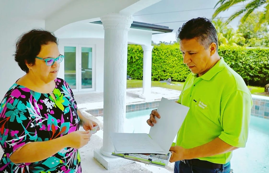 Artist paints on canvas in a light-filled studio.