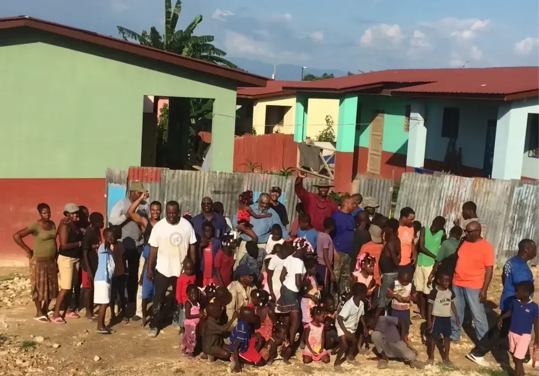 Will Jones with community members during a mission trip to Haiti, celebrating friendship, faith, and service to others.
