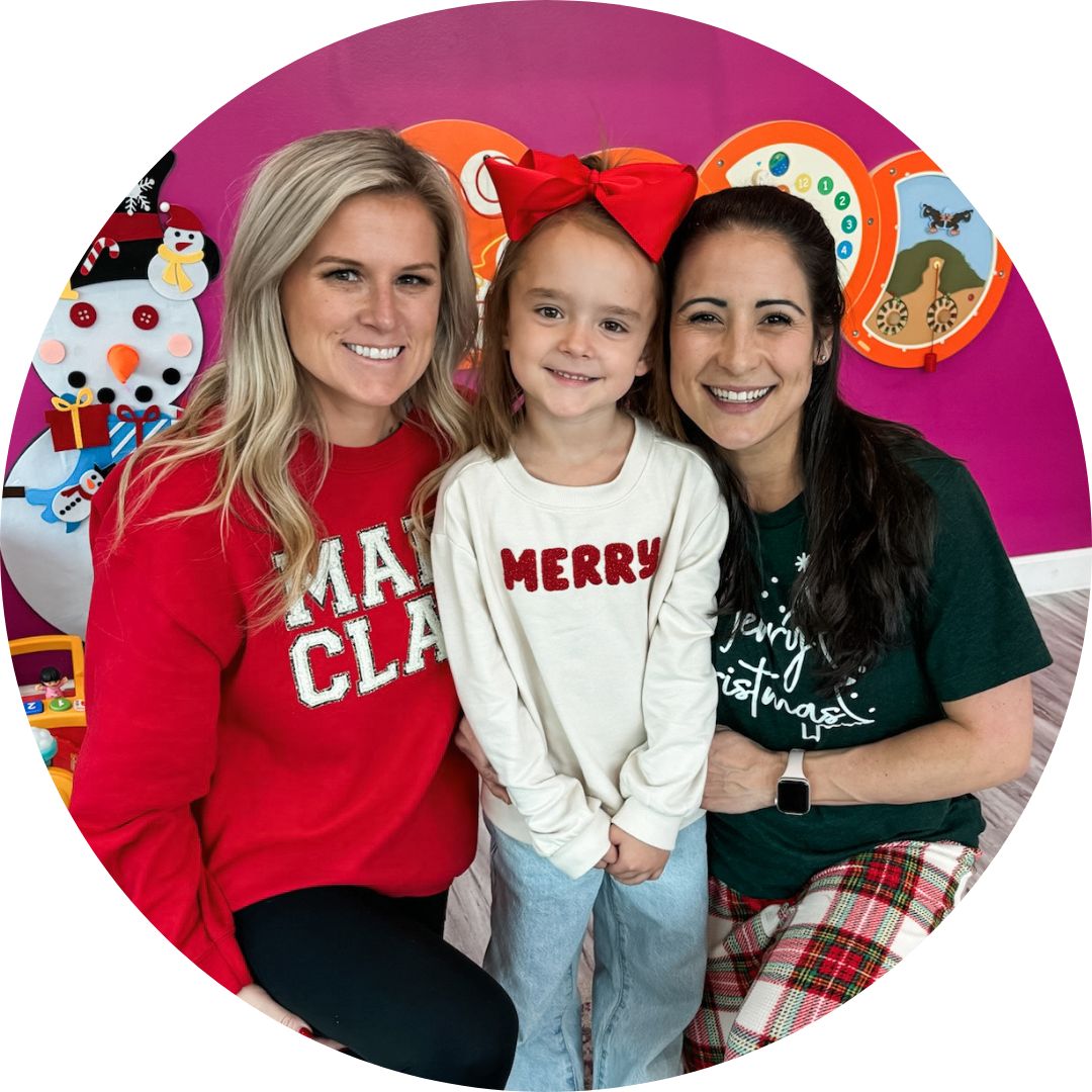 Family celebrating newborn with pediatric chiropractic care in a vibrant clinic setting, featuring a mother, father, young boy, and infant, emphasizing prenatal and pediatric wellness.
