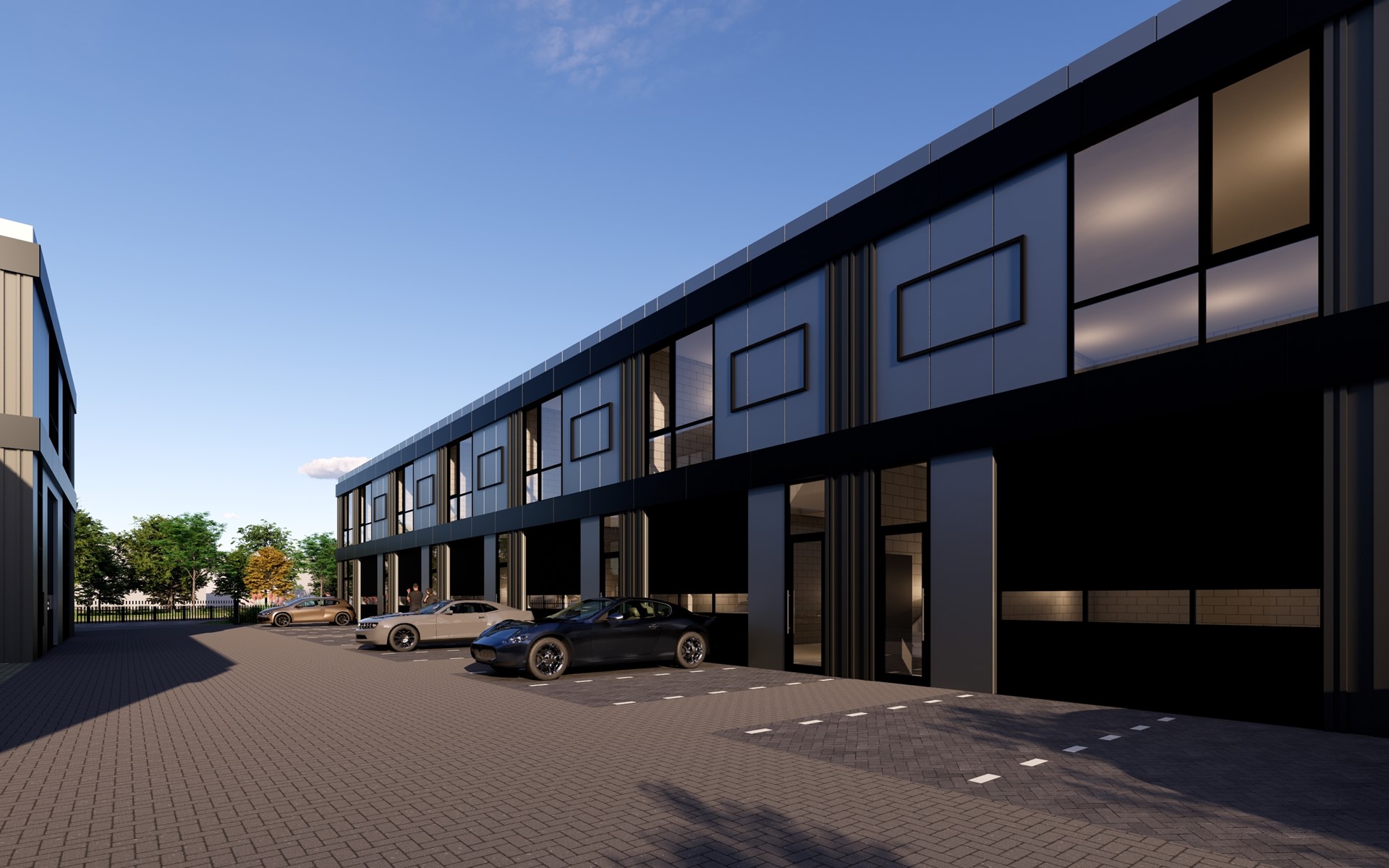 A 3:2 landscape photo of an upscale industrial unit exterior with premium cladding and large glazed office frontage; strong composition, golden-hour light, no people, emphasizes luxury finish and scale.