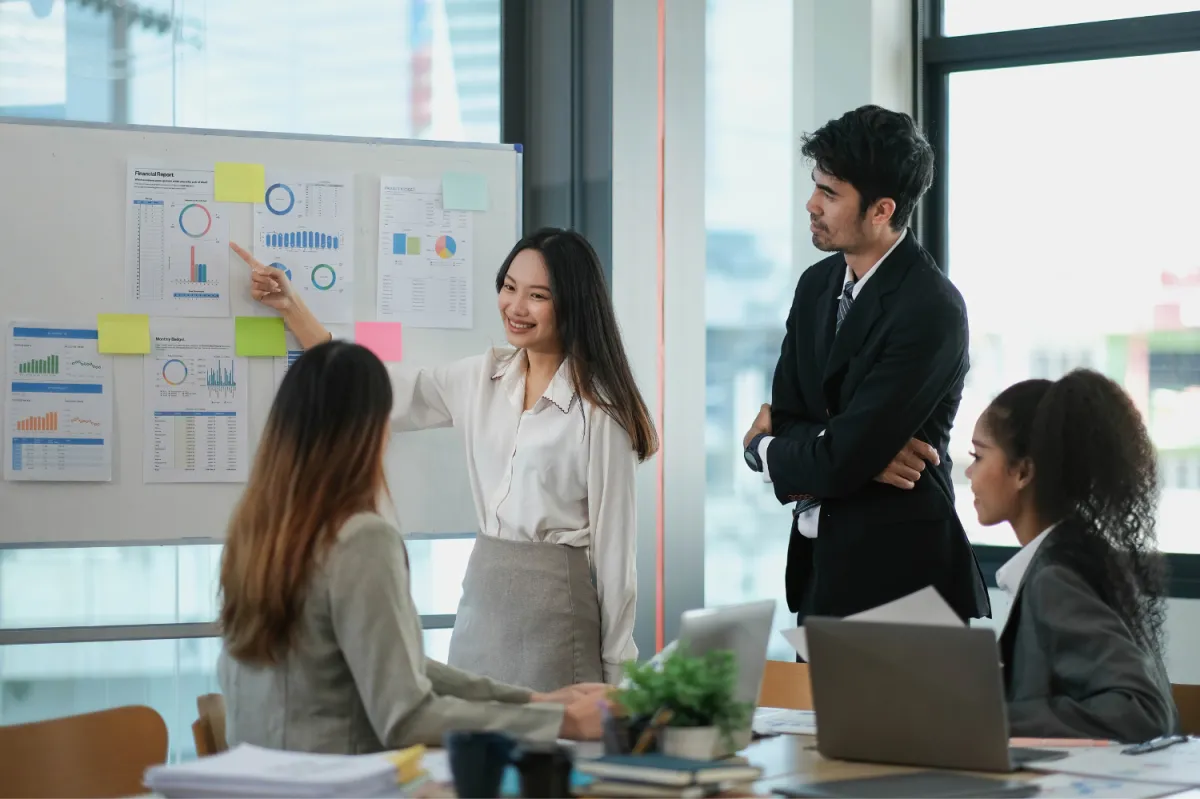 Drake 1859 team of professionals analyzing investment opportunities and oil well management strategies in an office setting.