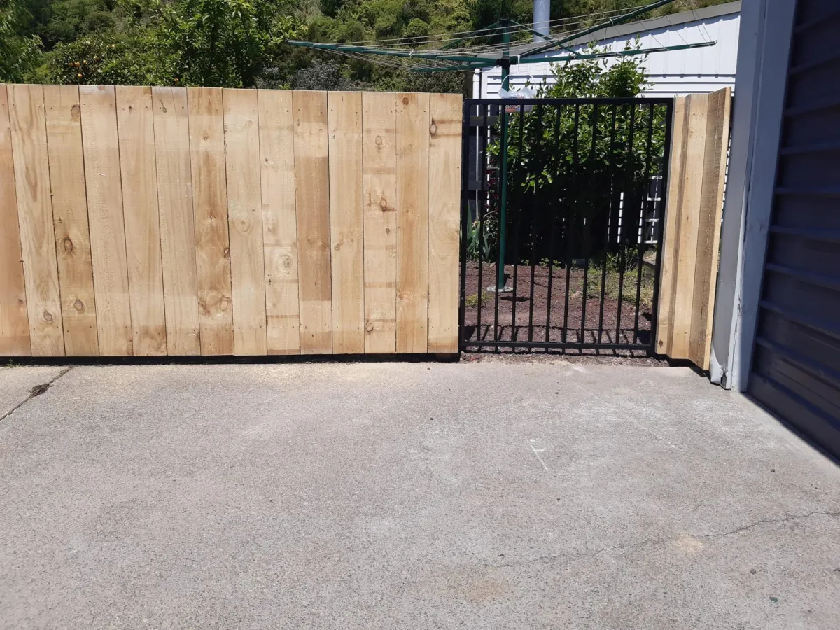 Wooden gate installation matching surrounding fence