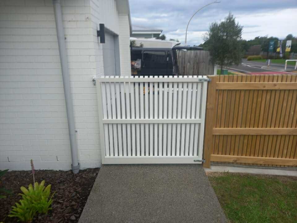 Wooden gate installation matching surrounding fence