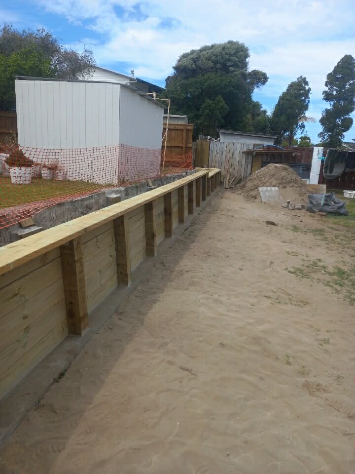 Retaining wall construction blending with landscaped slope