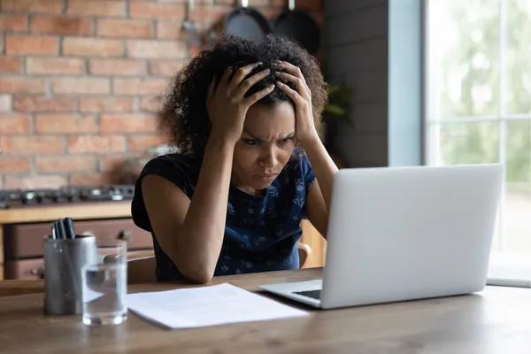woman staring at computer looking confused