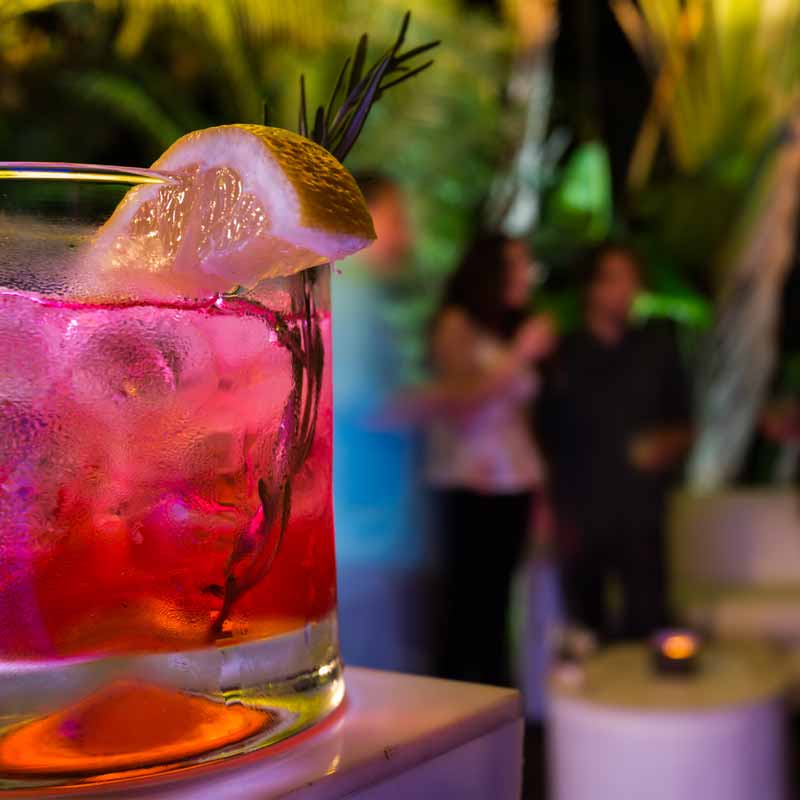 Cocktail in a glass with a citrus garnish.