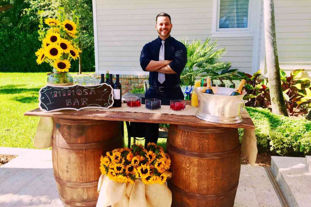 Bartender shaking a cocktail behind a bar.