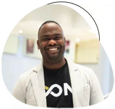 Andre Chin wearing white coat with black t-shirt.