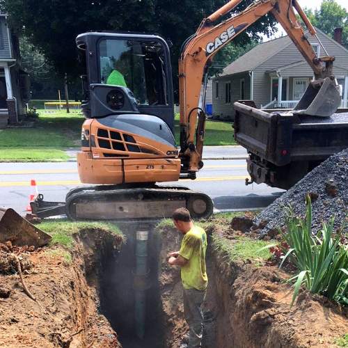 Two Beemer Plumbing workers excavating a sewer line in spring hill, ks