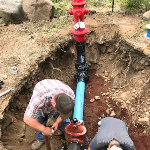 Two beemer plumbing, LLC employees install a new fire hydrant in Spring Hill, KS