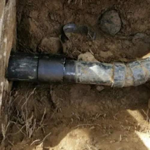 a closeup picture of the input line on a septic tank prior to repair in spring hill, ks