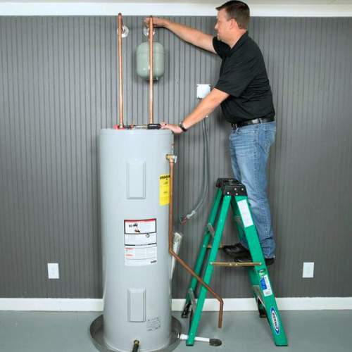 A plumber finishes installation of a new hot water heater in spring hill, ks