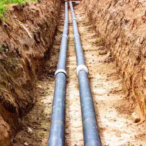 a new sewer line being installed in a new lot in Wellsville, KS