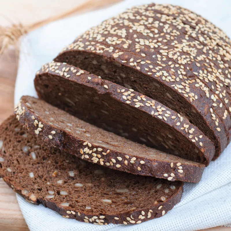 Hearty multigrain bread with seeds, representing nourishing support and sustenance for overwhelmed moms during group coaching