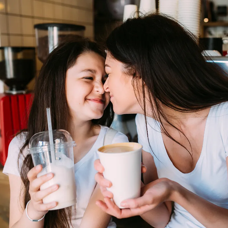 Mom and daughter sharing a sweet drink, representing consistent monthly support, bonding, and ease for moms