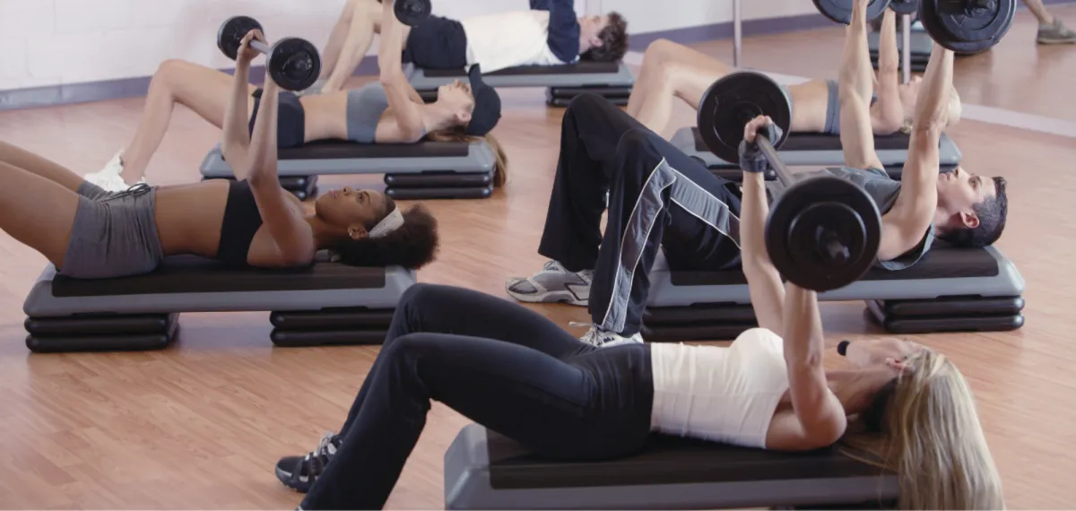 Busy mom doing strength training with dumbbells at home while staying active and healthy.