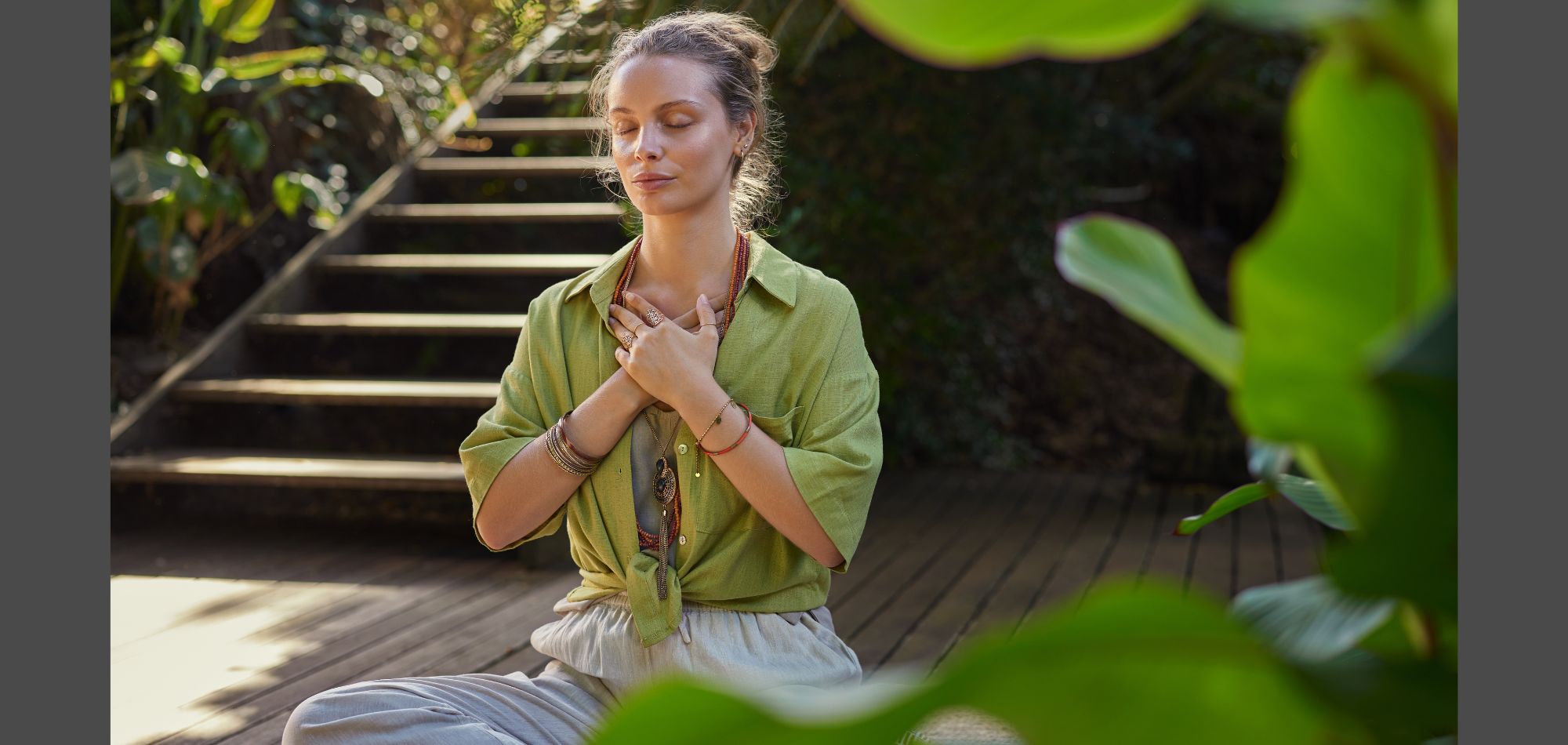 Woman practicing emotional grounding with her hands over her heart, representing self-regulation and inner calm.