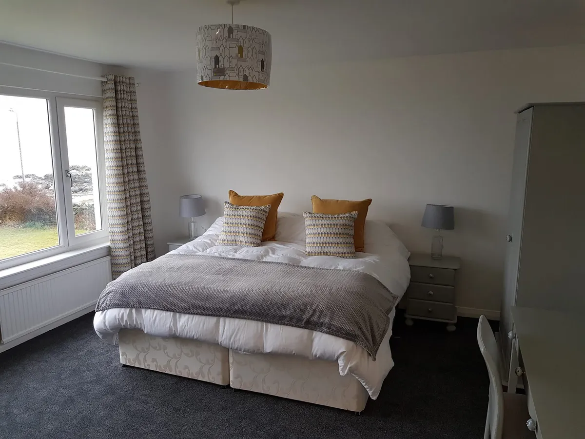 Bedroom 1 with spacious superking bed and natural daylight