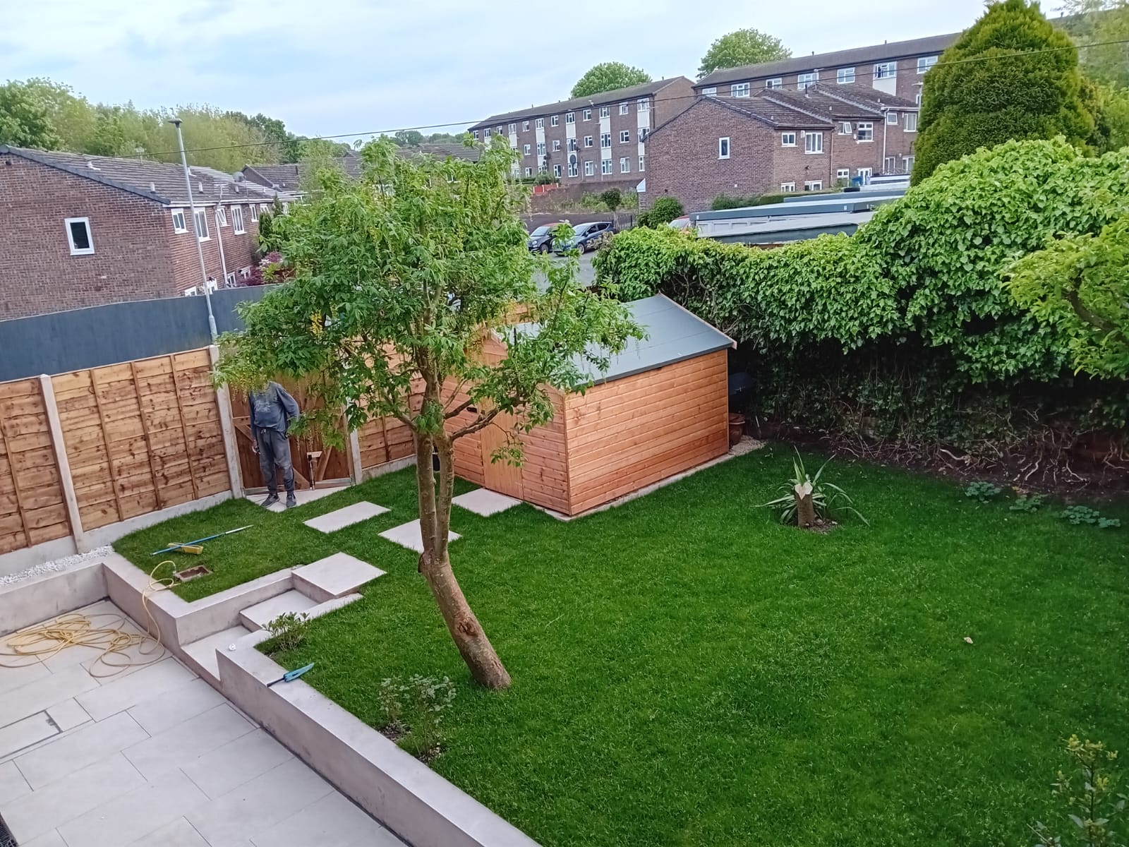 Landscaper in Old Trafford laying new turf and paving in a rear garden
