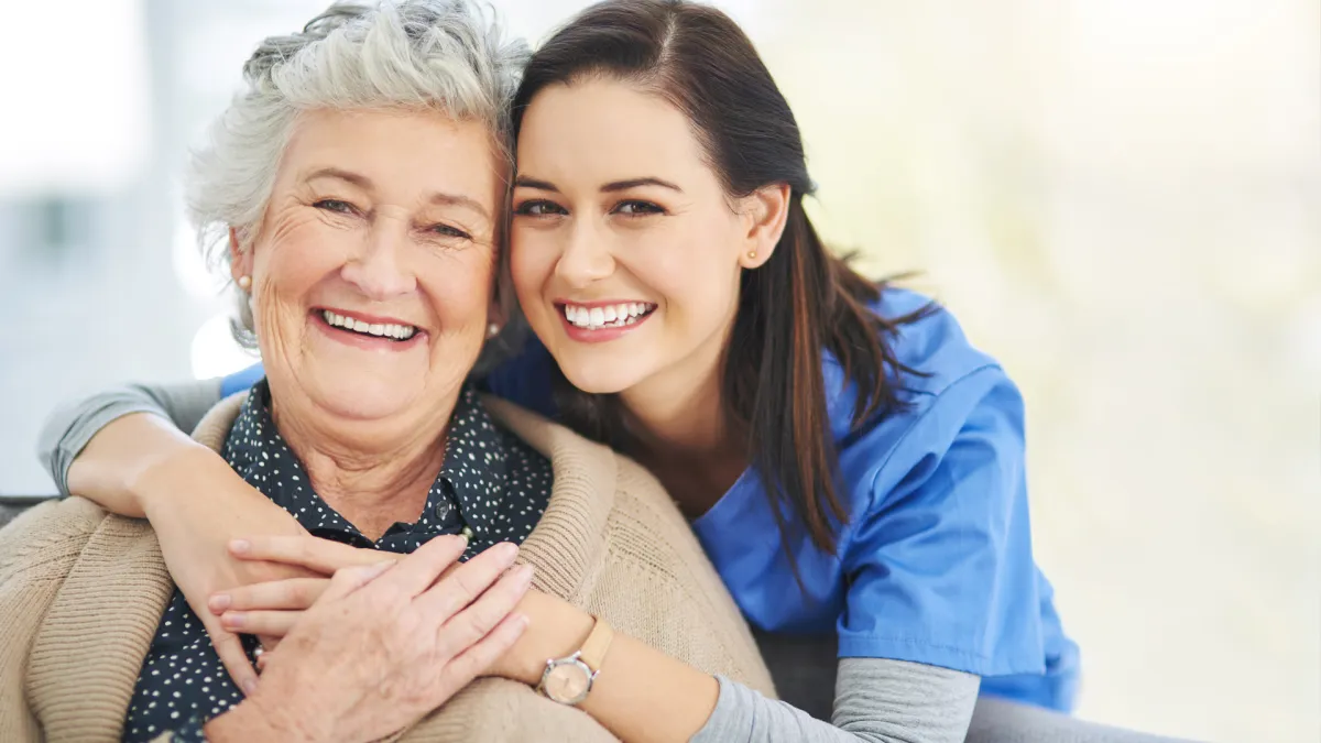 Happy senior woman enjoying companionship and emotional connection with dedicated carer