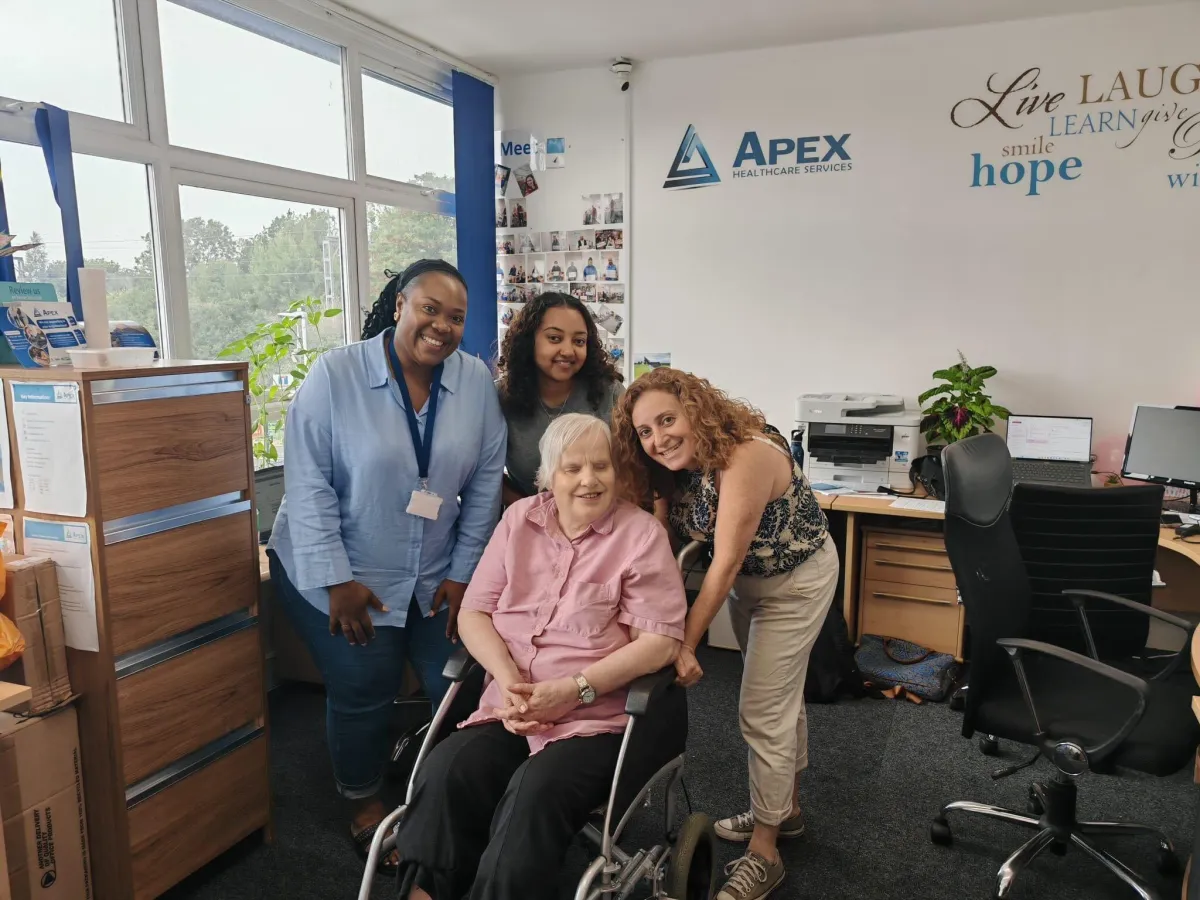 Elderly lady with members of the care team