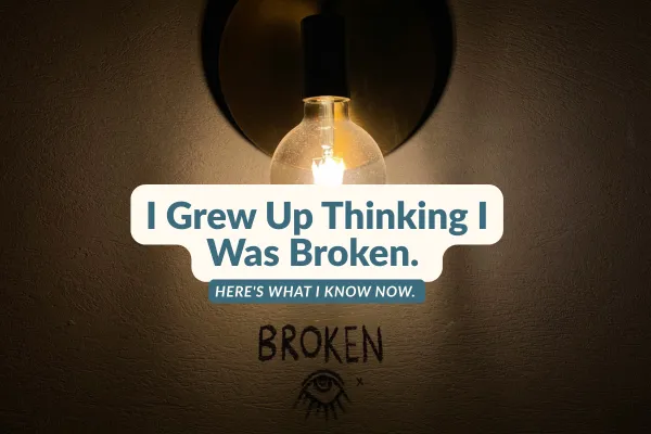 Lit lightbulb on a wall with text: 'I Grew Up Thinking I Was Broken. Here's what I know now.' Graffiti-style 'BROKEN' and an eye illustration below.