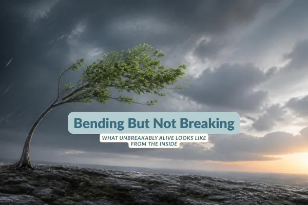 Wind-bent tree on a rocky ridge under storm clouds. Text: 'Bending But Not Breaking — What Unbreakably Alive Looks Like From The Inside.'