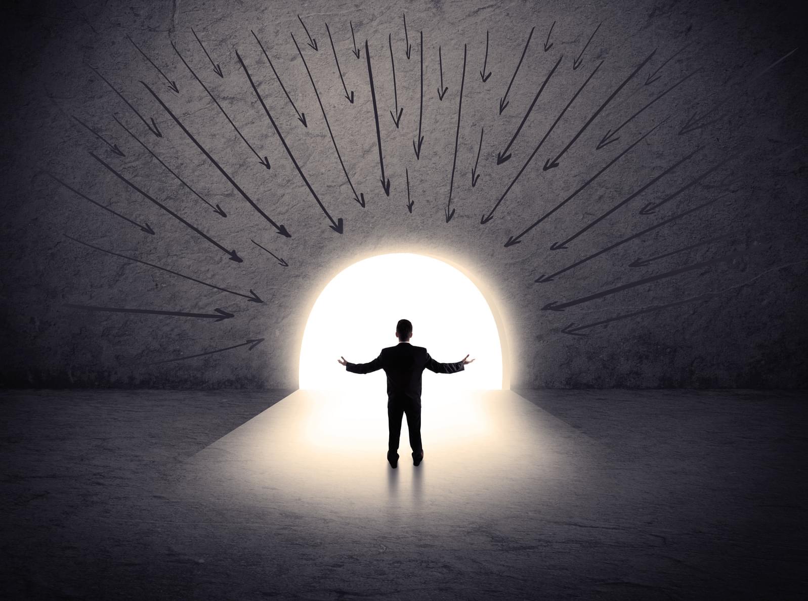Man stood in entrance to tunnel with arms outstretched