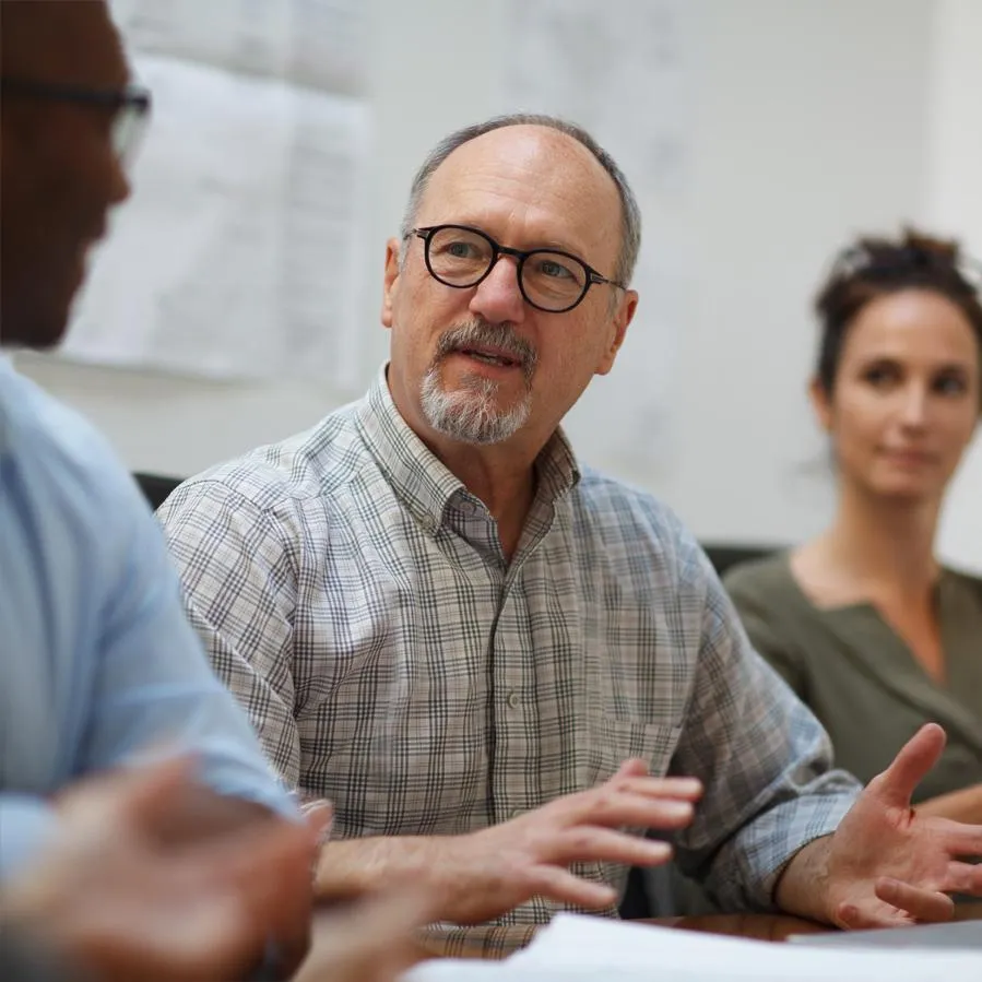 A team leader meets with his team members.