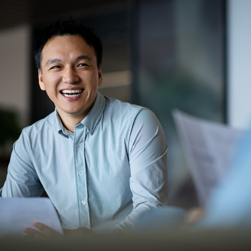 Business professional in a conference room reviewing profit and loss statements