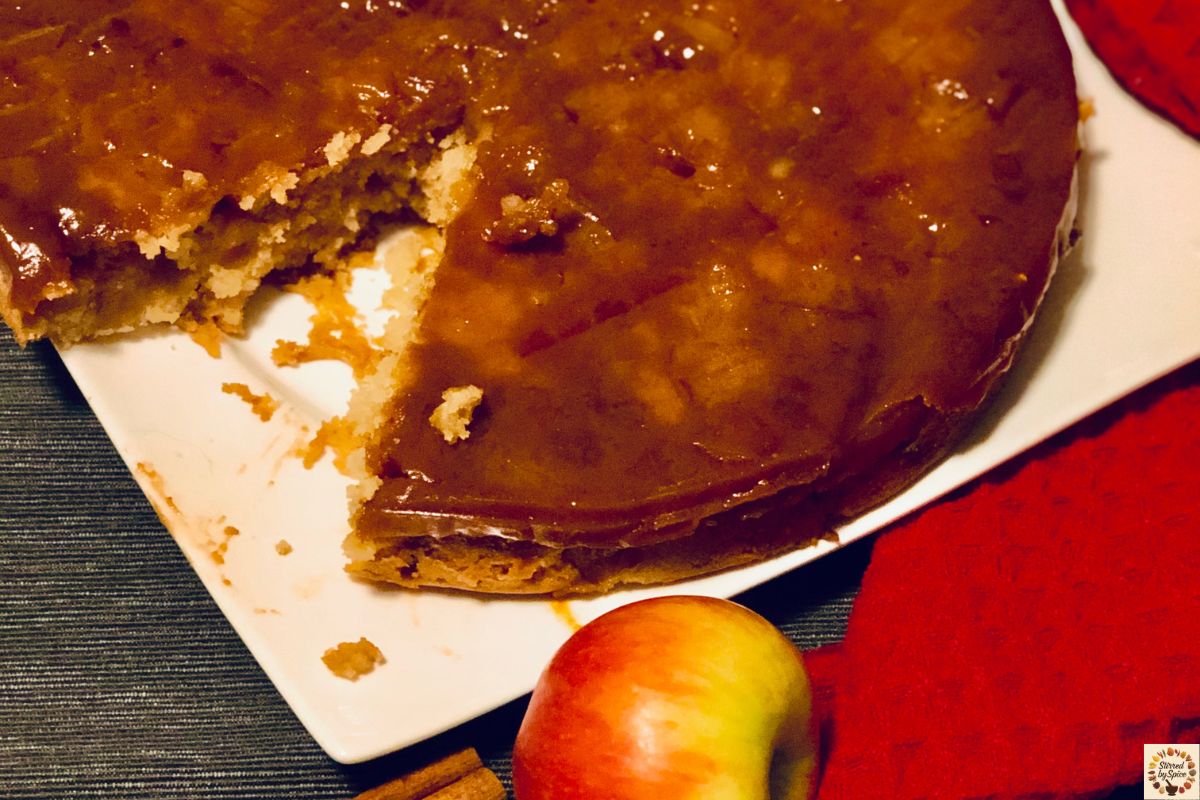 Eggless caramel apple cake with soft baked apples and buttery caramel ribbons.