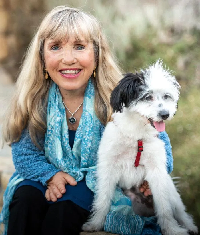 Photo of Peggy smiling and her dog Chelsea