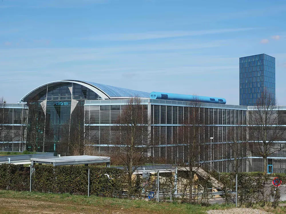 Exterior of a modern commercial building with a curved glass roof