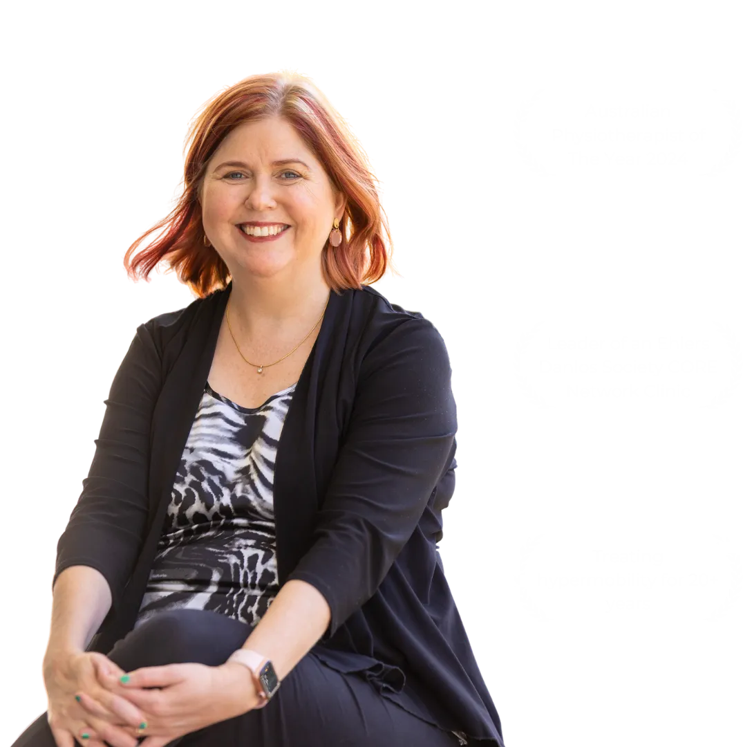 Sharon a woman with red hair wearing a black suit jacket and a zebra shirt. Australian physiotherapy of the year 2024, leader of an ehlers danlos society core network clinic, treating hypermobility for twenty plus years.