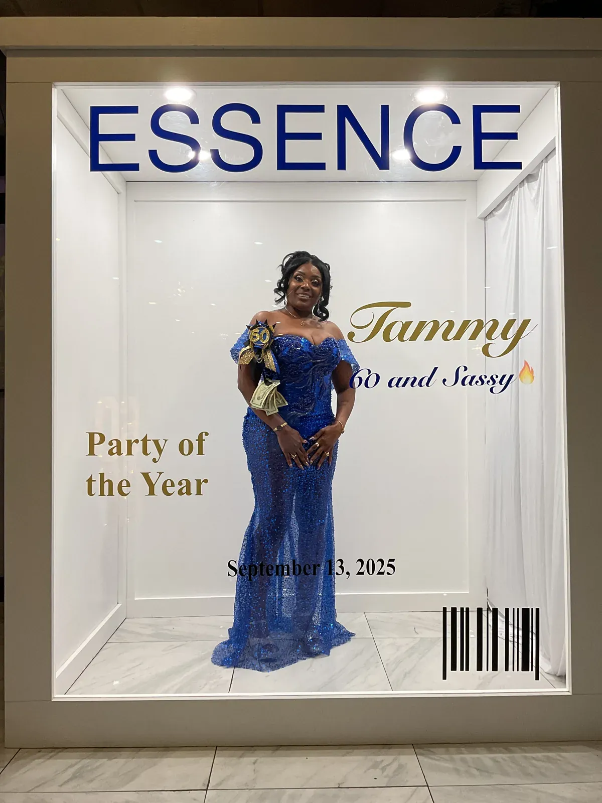 Guest in a blue dress posing inside a personalized Essence magazine cover photo booth