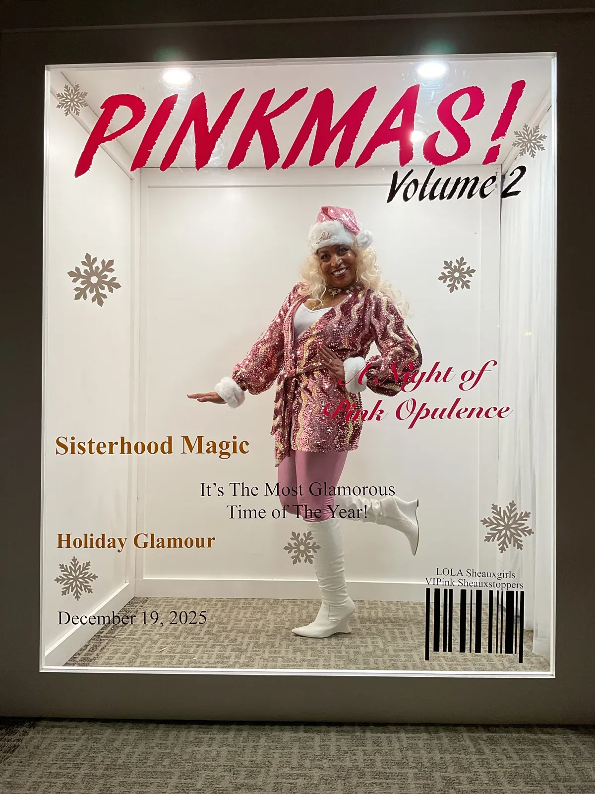 Guest posing inside a personalized Pinkmas magazine cover photo booth
