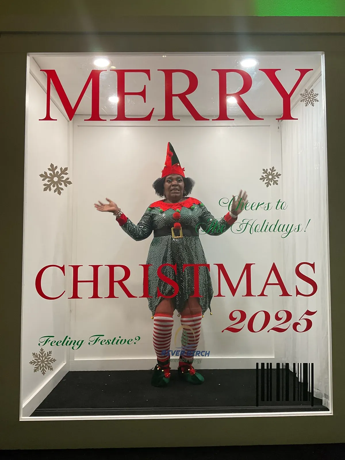 Guest in a festive costume inside a Merry Christmas magazine cover photo booth
