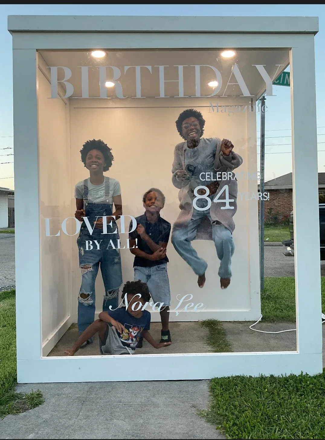 Children posing inside a customized birthday magazine cover photo booth