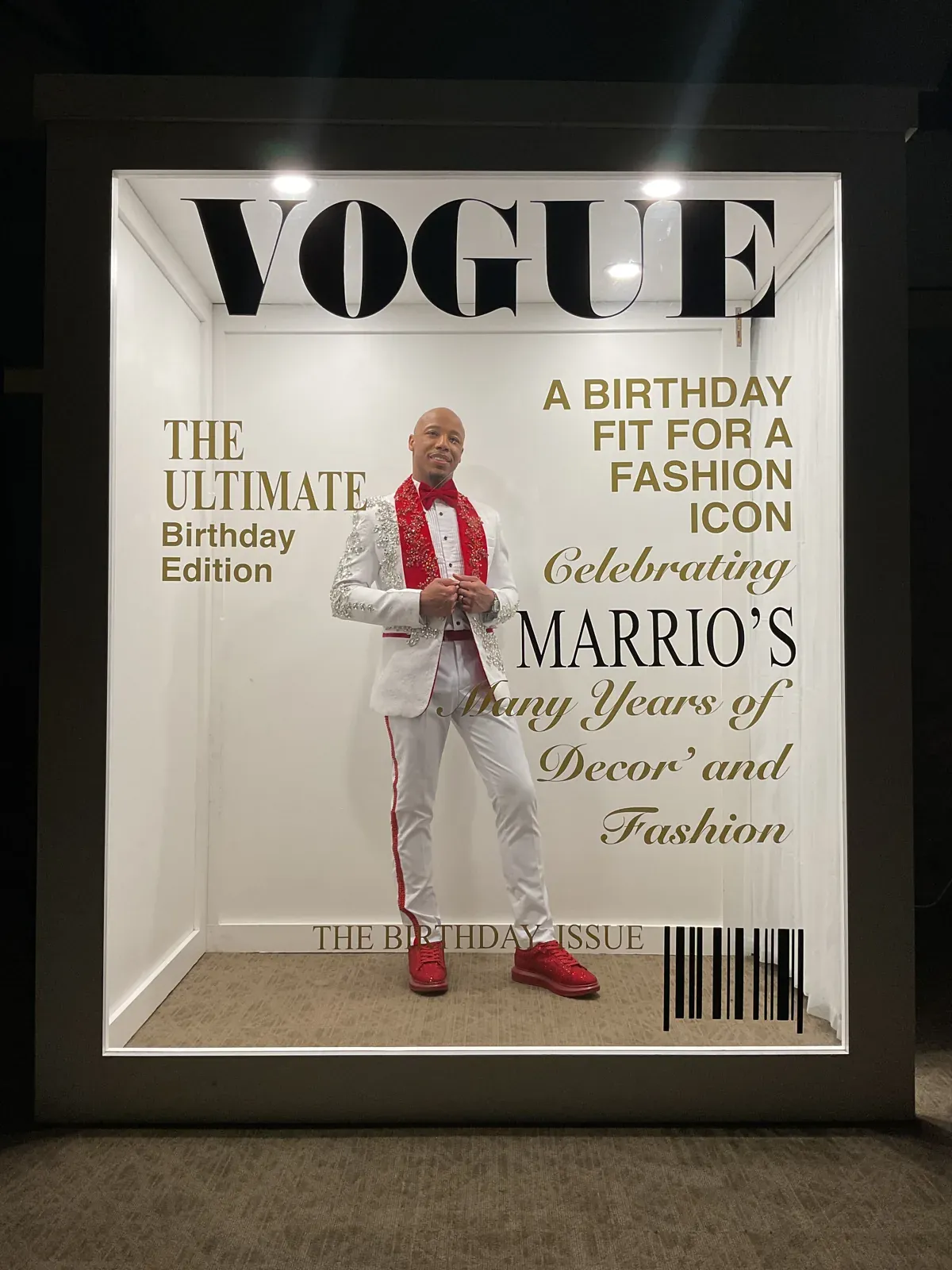 Guest posing inside a personalized Vogue birthday magazine cover photo booth