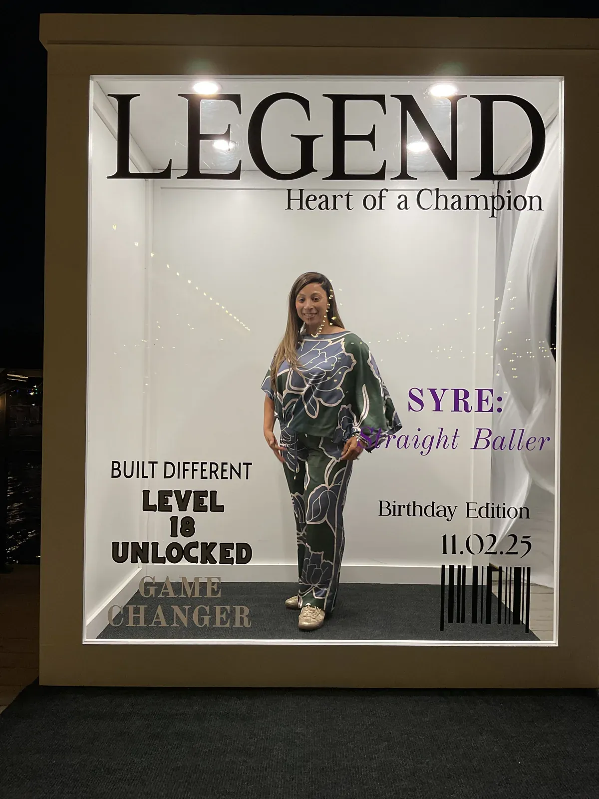 Guest posing inside a Legend birthday magazine cover photo booth